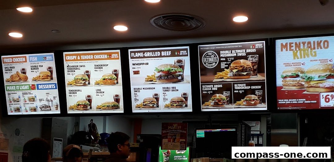 A digital menu board displaying various Burger King meals, including burgers, fried chicken, and fish options.