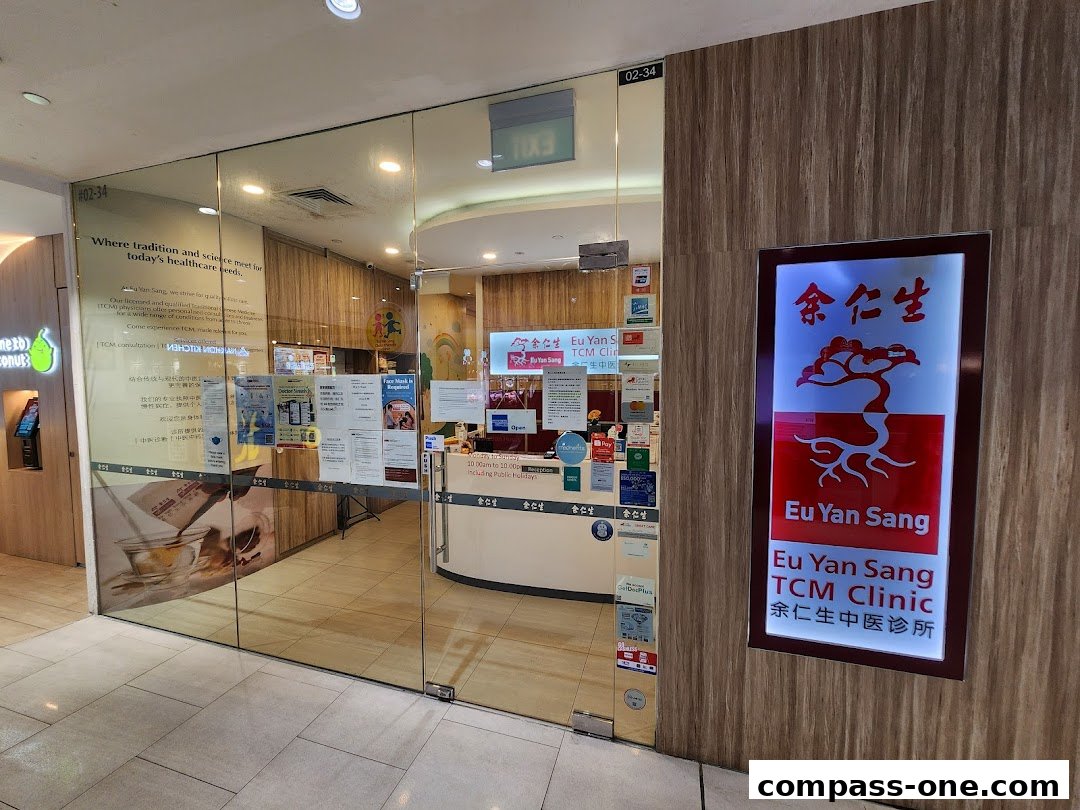 The entrance of Eu Yan Sang TCM Clinic, featuring glass doors and a prominent illuminated sign.