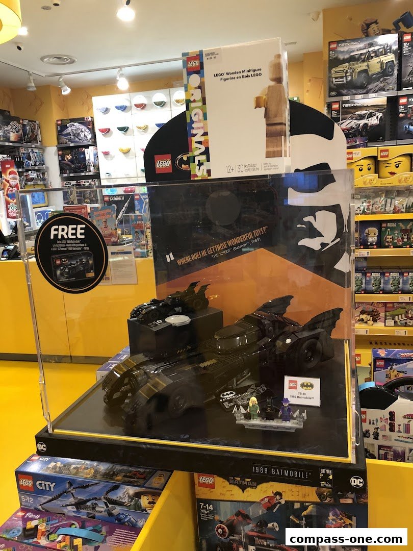 Interior view of a LEGO store showcasing a display of the 1989 Batmobile set.