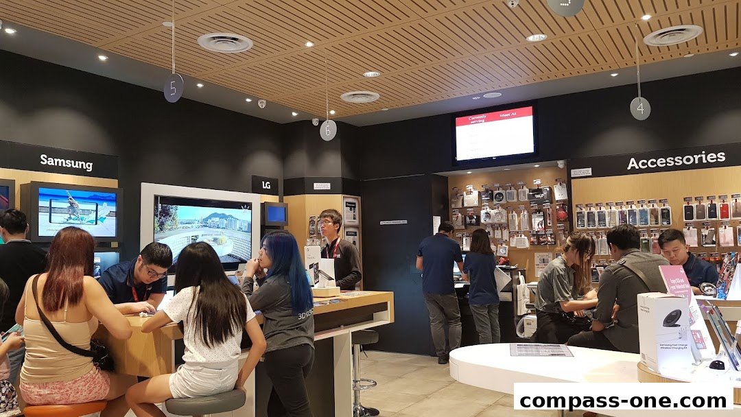 Customers are browsing phones and accessories at a Singtel Exclusive Retailer store.