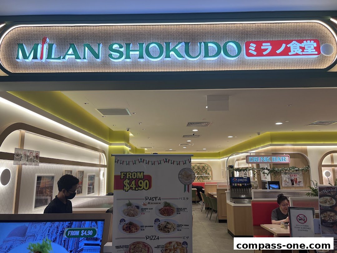 The entrance of Milan Shokudo, a Japanese-Italian restaurant, with a menu displayed.