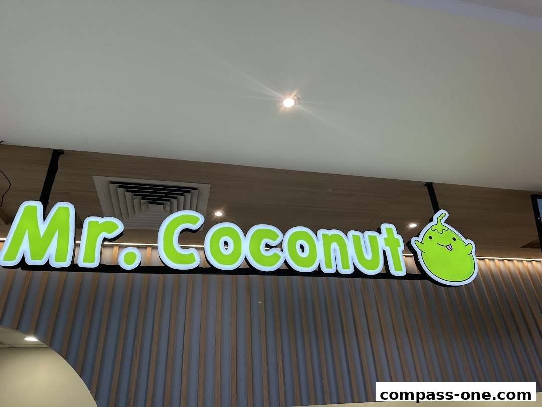 The illuminated sign for Mr. Coconut, featuring a cartoon coconut character.