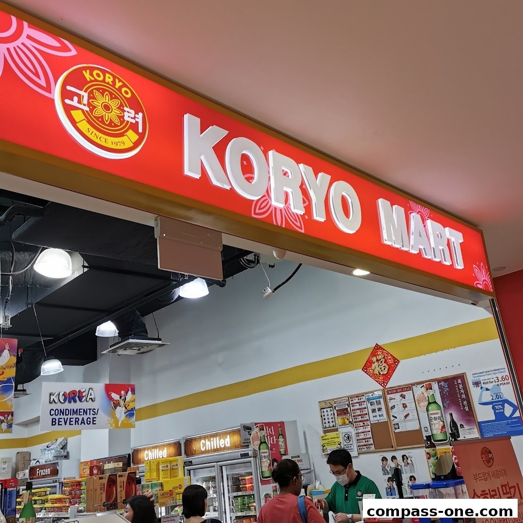 The entrance of Koryo Mart, a Korean grocery store, with its prominent signage and displays of products.