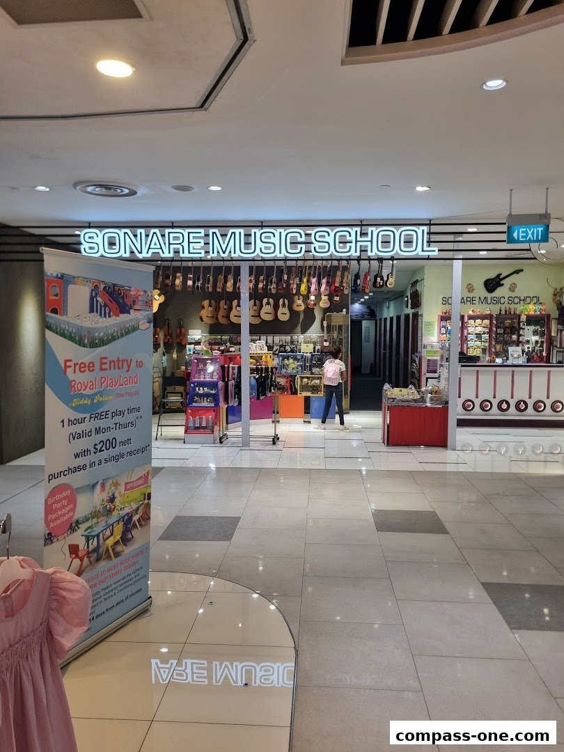 The entrance of Sonare Music School, showcasing musical instruments and a promotional banner.