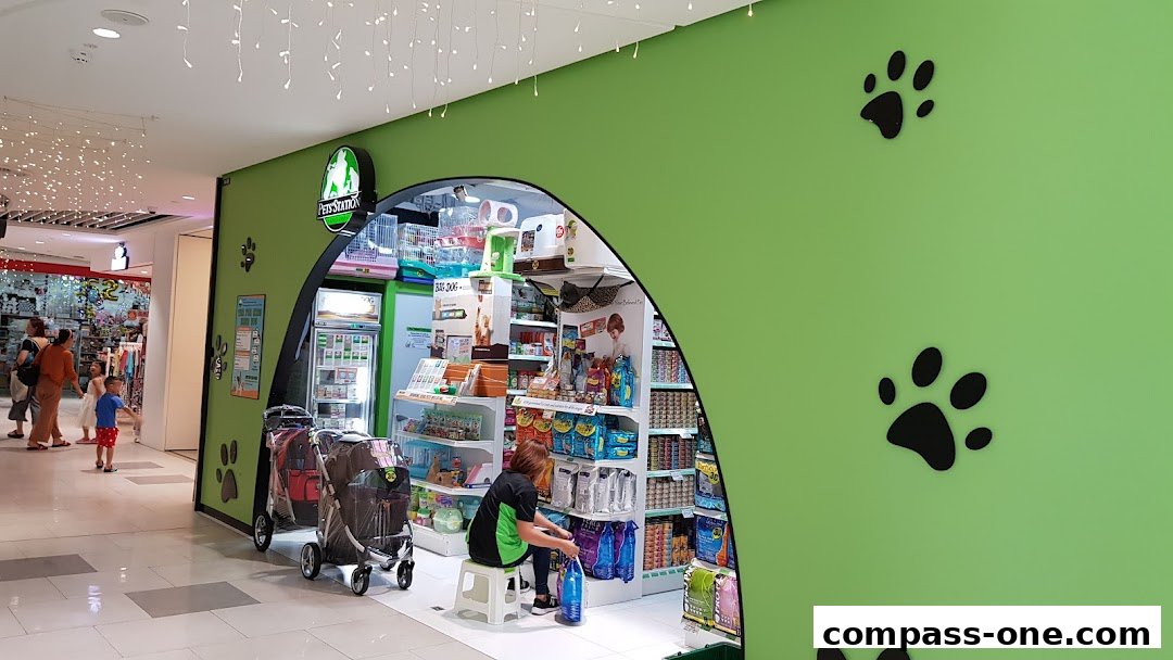 Pets Station shop entrance with pet supplies and a staff member inside.