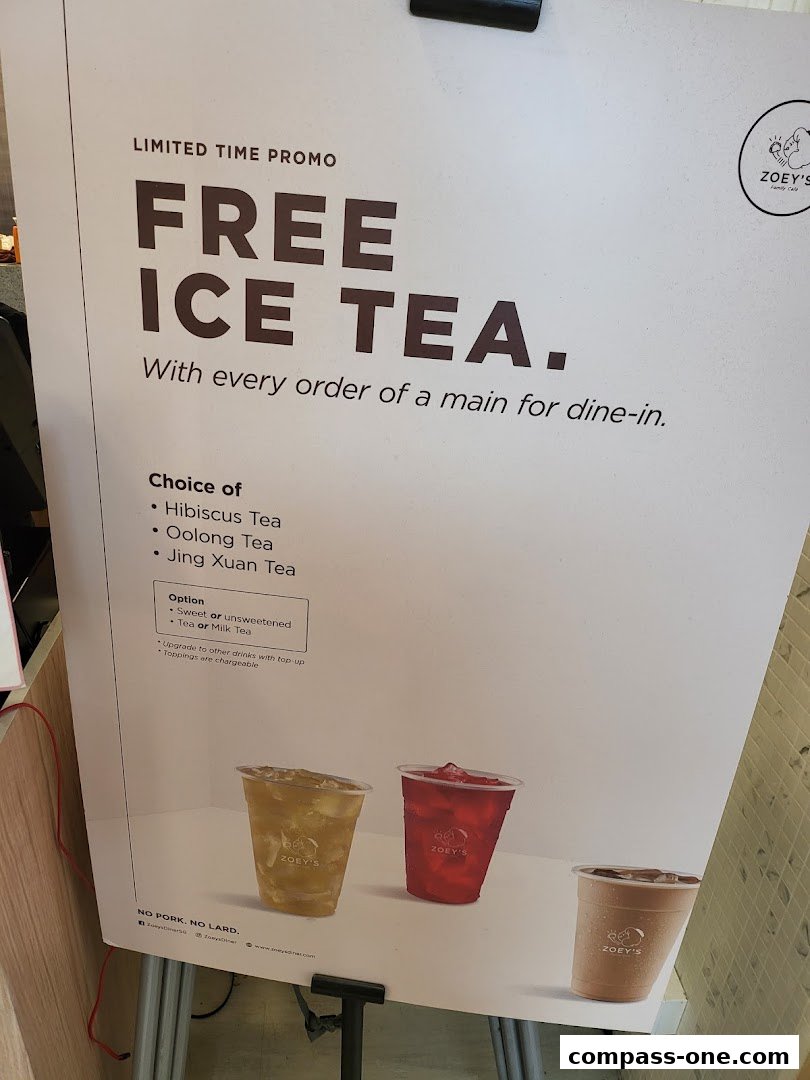 A promotional poster for Zoeys offering free ice tea with main course orders.