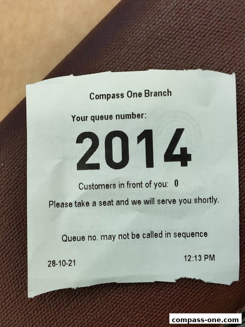 A queue ticket from OCBC Bank Compass One Branch with number 2014.