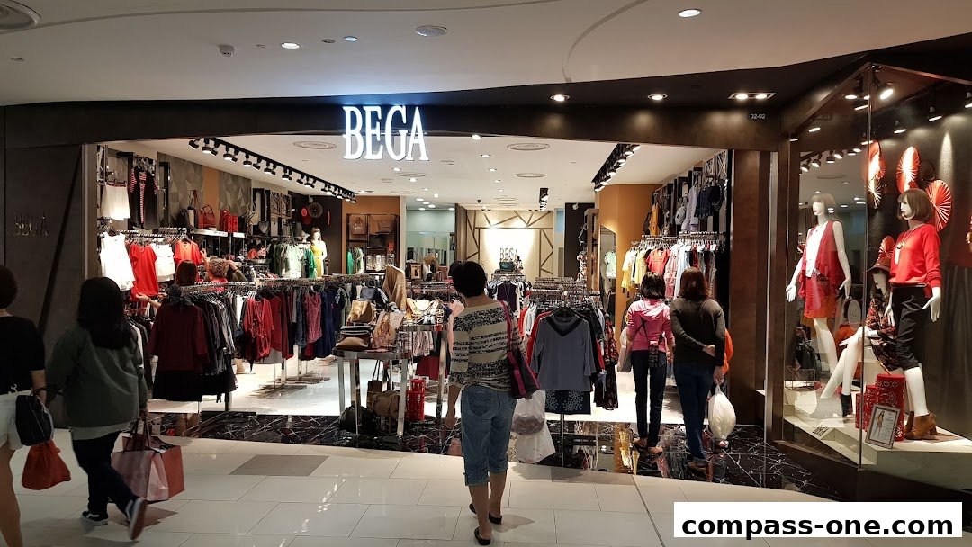 BEGA store interior showcasing racks of women's clothing and mannequins in the window.