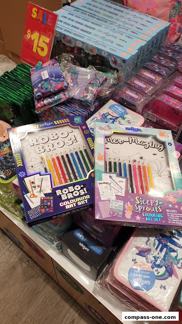 A display of Smiggle art sets and stationery items, including a sale sign.
