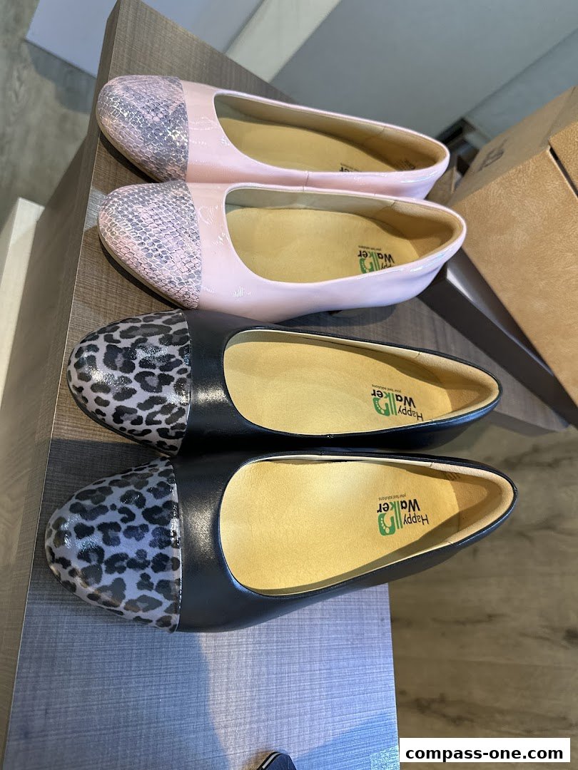 A close-up view of two pairs of stylish women's flat shoes with unique toe designs.