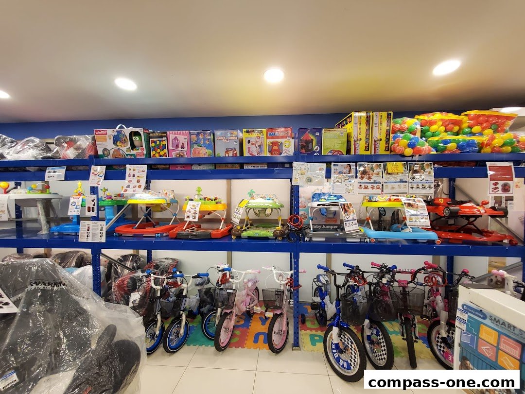 A wide selection of baby walkers, toys, and bicycles displayed on shelves in a retail store.