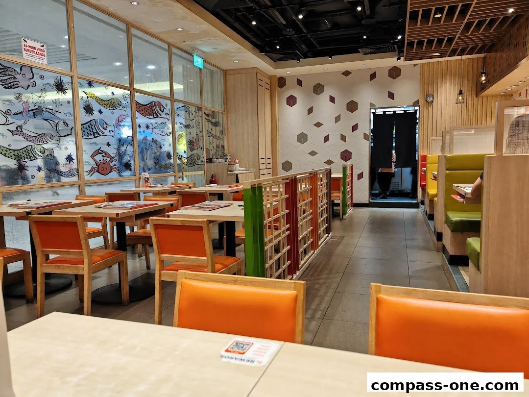 Interior view of a Japanese restaurant with tables, chairs, and booth seating.