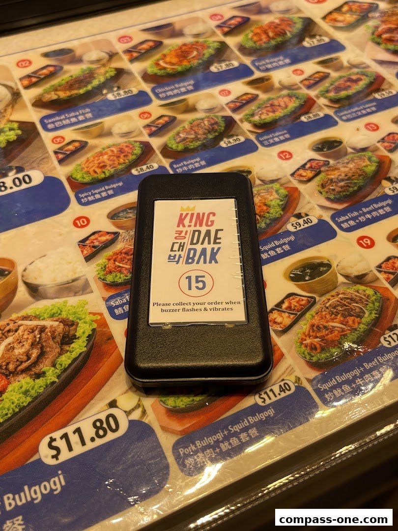 A menu from King Dae Bak Korean restaurant featuring various Korean dishes with images and prices.