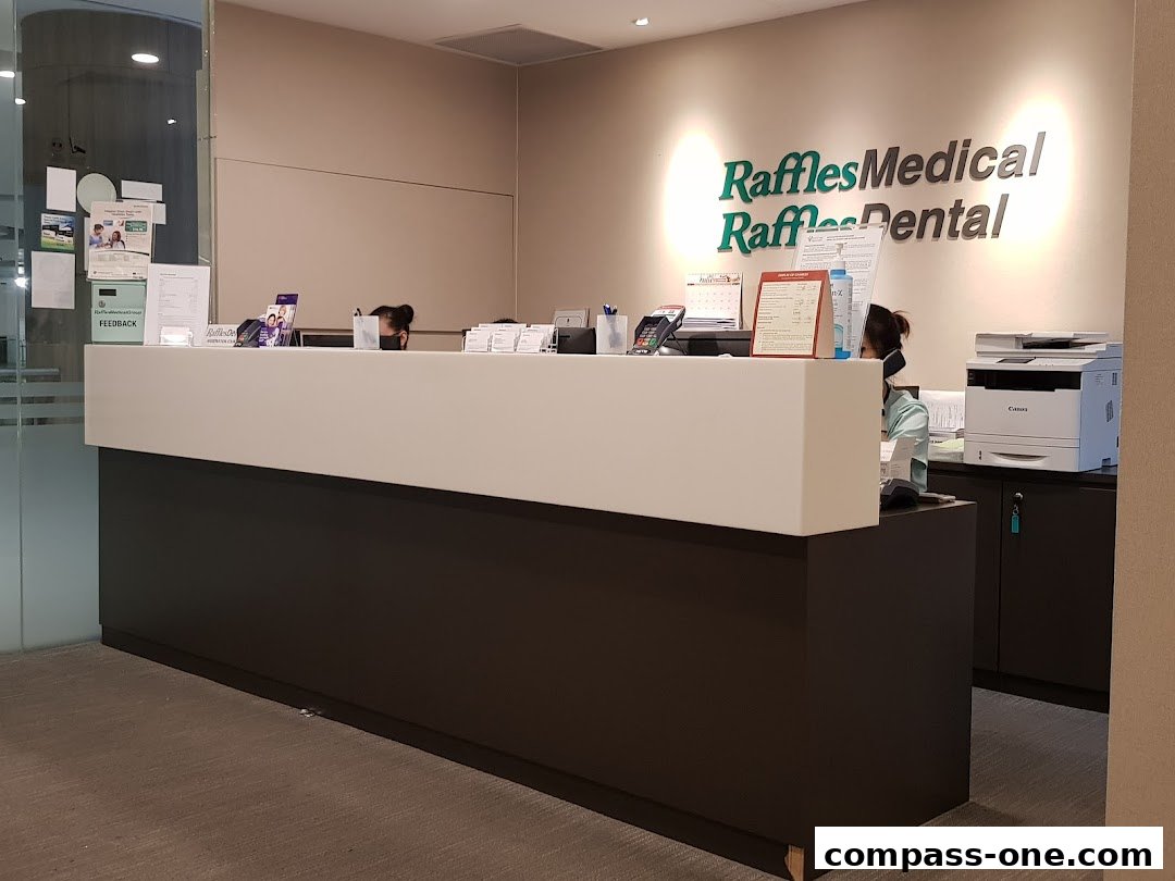 The reception area of Raffles Medical Dental with staff at the counter.