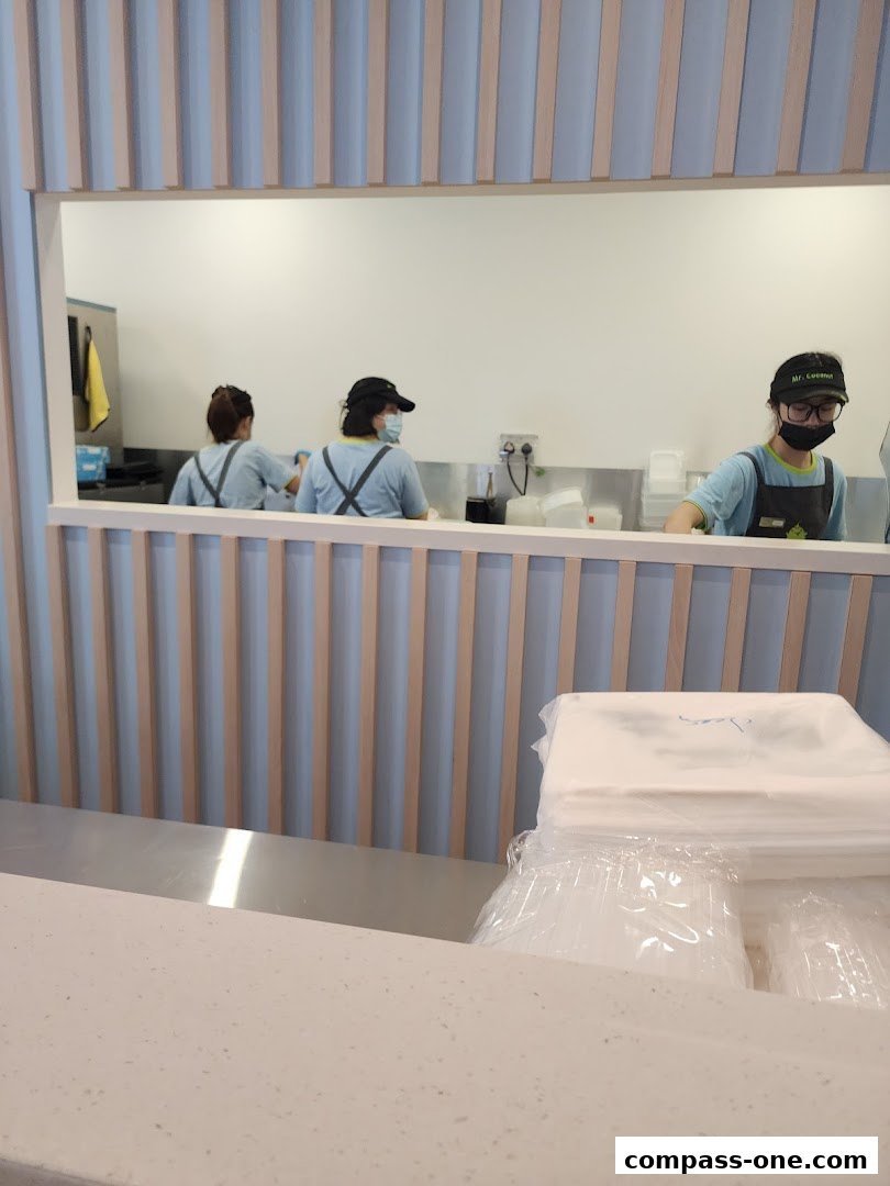 Staff members working behind the counter at Mr. Coconut.