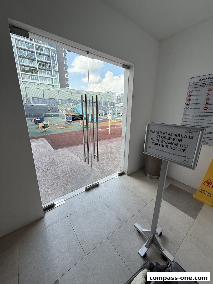 Entrance to a water playground with a sign indicating it's closed for maintenance.