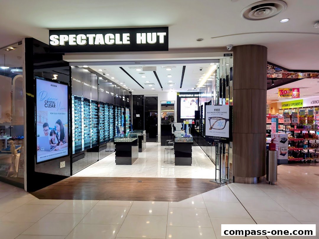 The entrance of Spectacle Hut, an optical shop, showcasing a wide selection of eyewear and promotional signage.