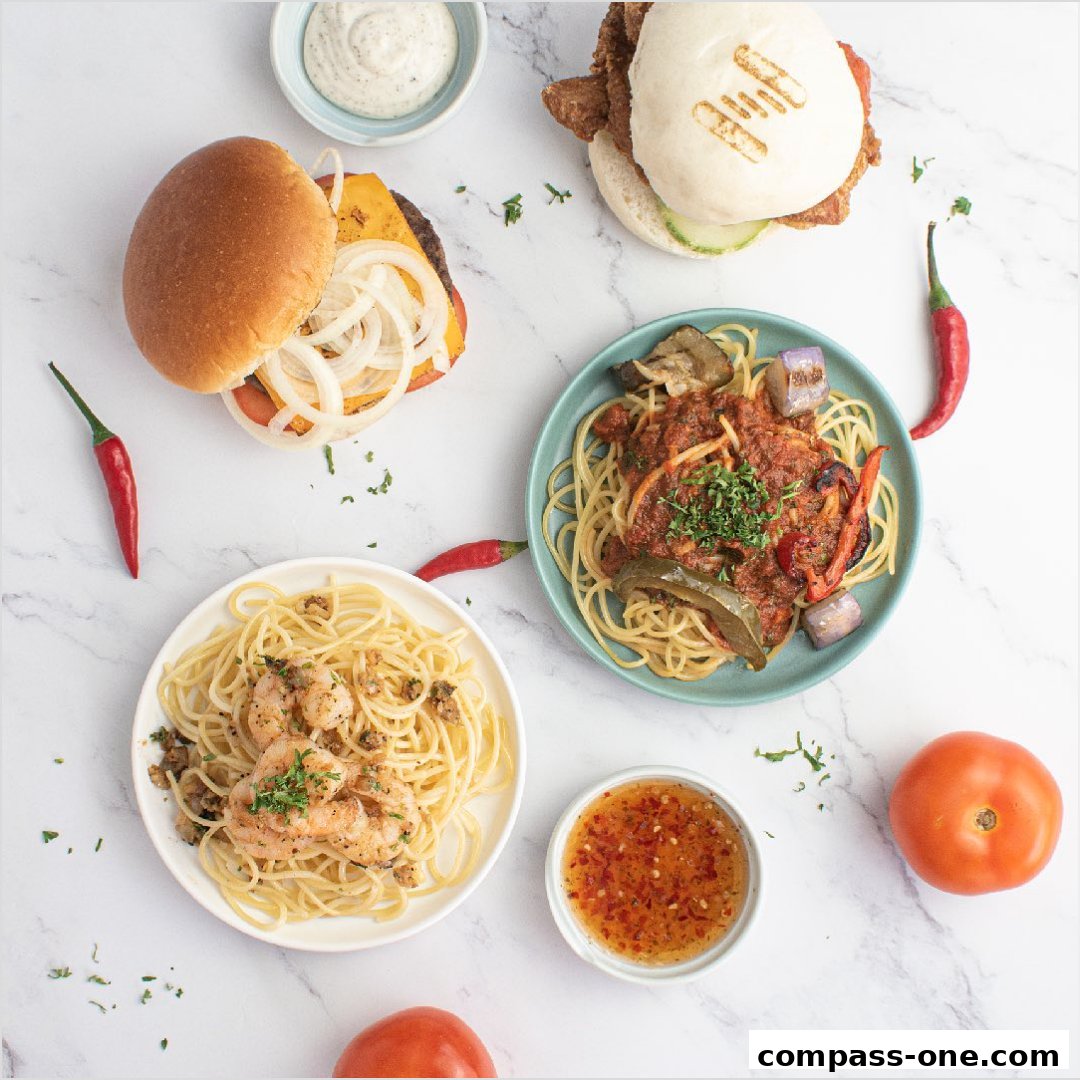 A top-down view of a variety of delicious food items, including burgers and pasta dishes.