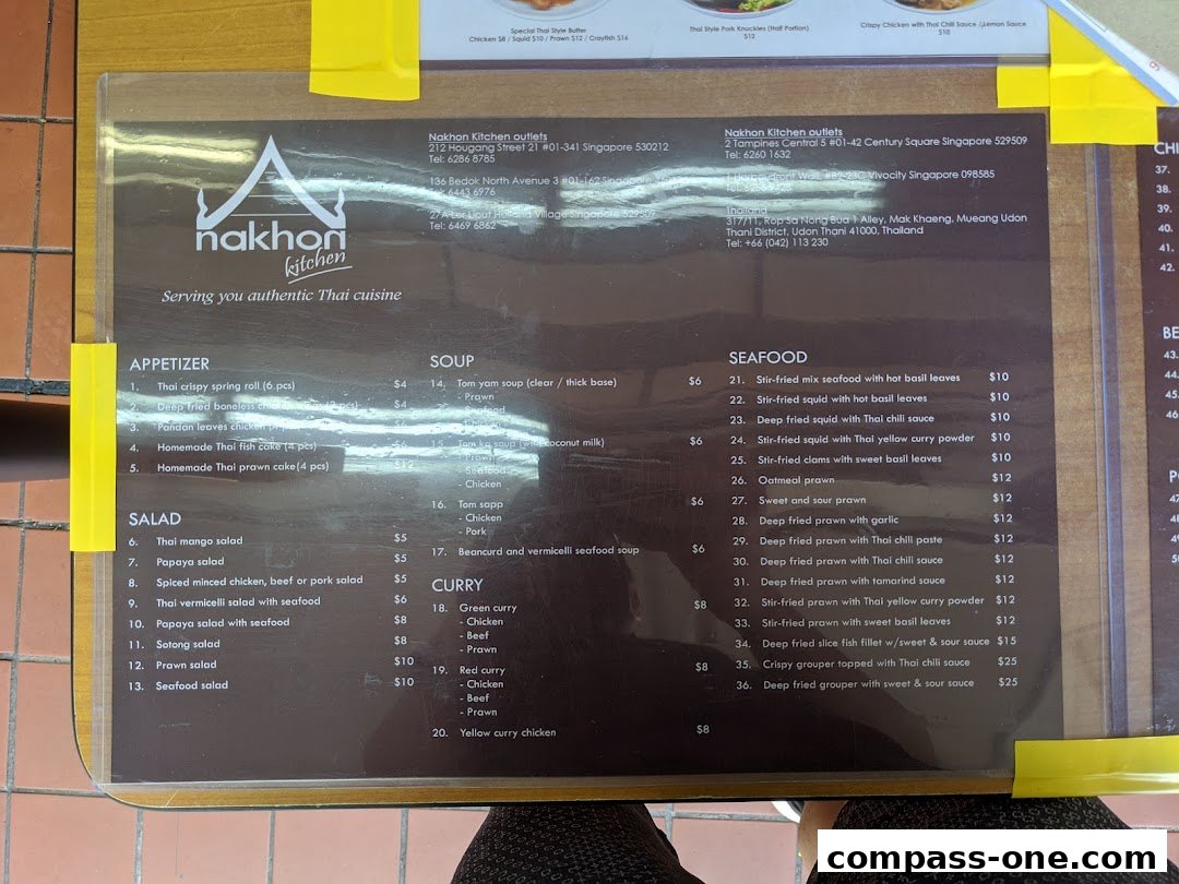 A menu from Nakhon Kitchen, featuring Thai appetizers, salads, soups, seafood, and curries with prices.