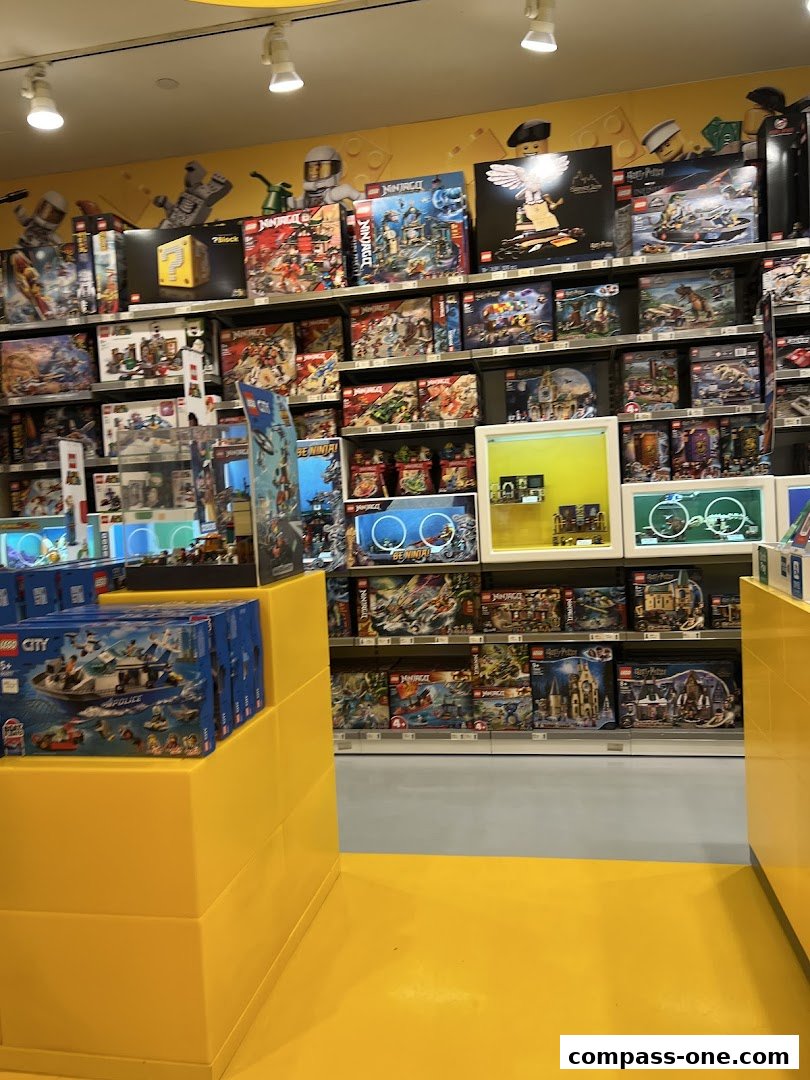 Interior view of a LEGO store with shelves full of various LEGO sets.