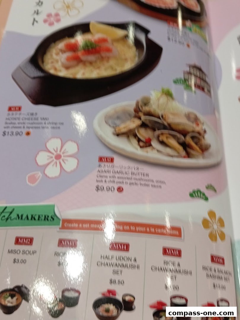 A menu featuring Japanese dishes like Hotate Cheese Yaki and Asari Garlic Butter, with set meals.