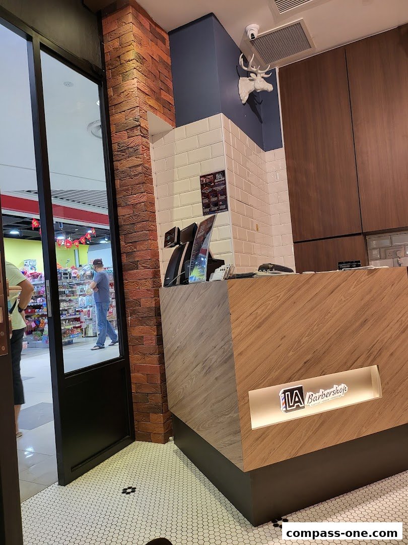 Interior view of LA Barbershop with a reception desk and a deer head decoration.
