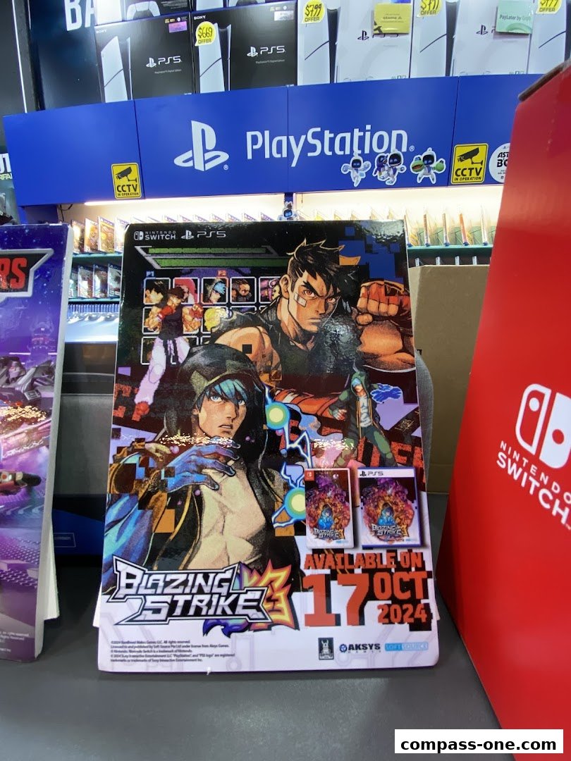 A display of video games and PlayStation consoles with a 'Blazing Strike' advertisement.