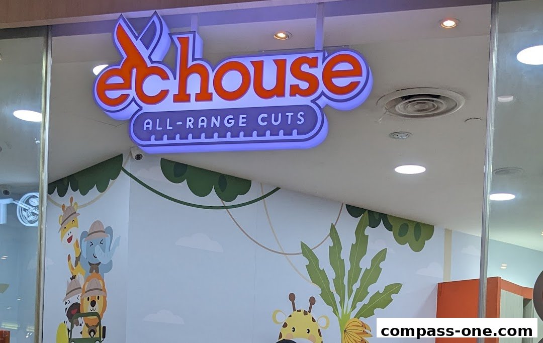 The illuminated sign for EC House All Range Cuts, featuring playful animal graphics on the wall.