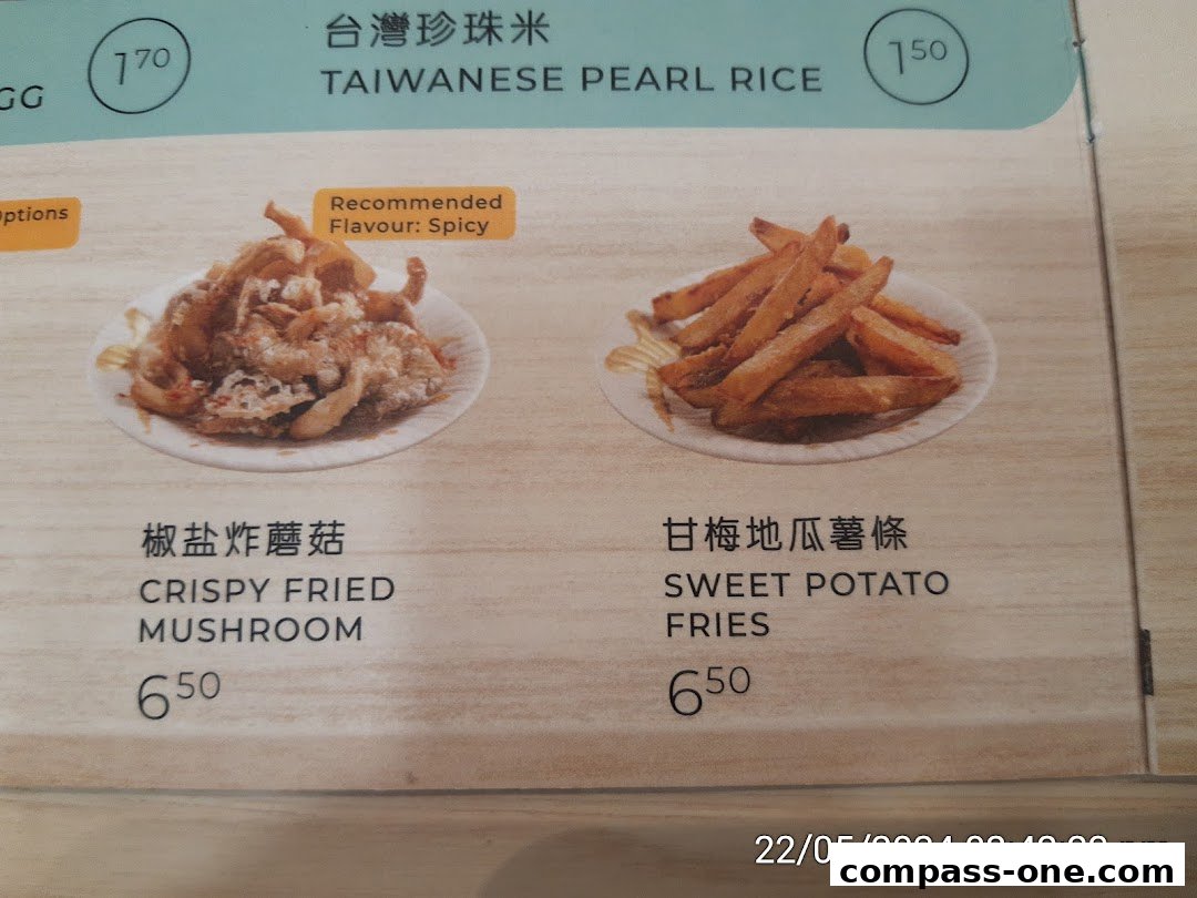 A menu display showing crispy fried mushroom and sweet potato fries with prices.