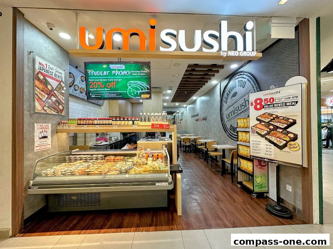The exterior of an Umi Sushi restaurant with a display of sushi and a promotional poster.
