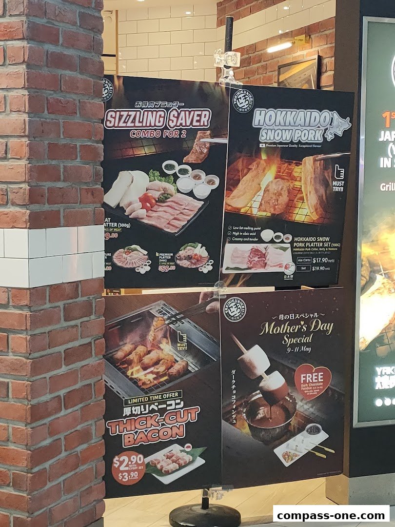 Advertisements for Yakiniku Like Compass One featuring various meat platters and specials.