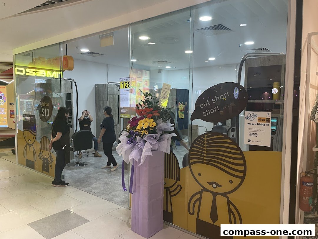 Okinawa Hair Salon interior with staff and a haircut promotion displayed.