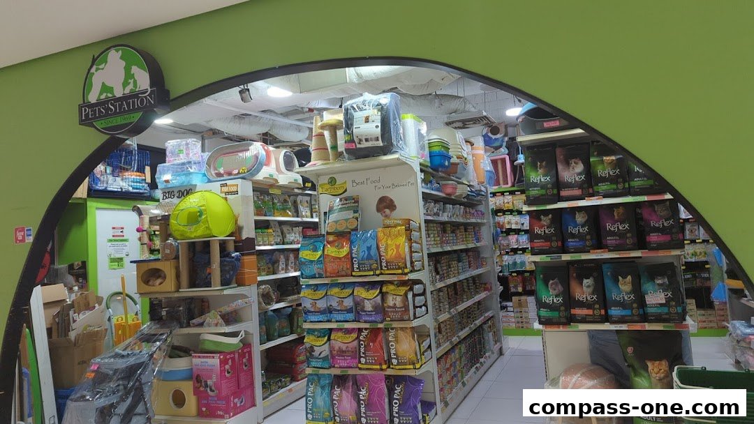 The entrance to a pet store with shelves stocked with pet food and accessories.