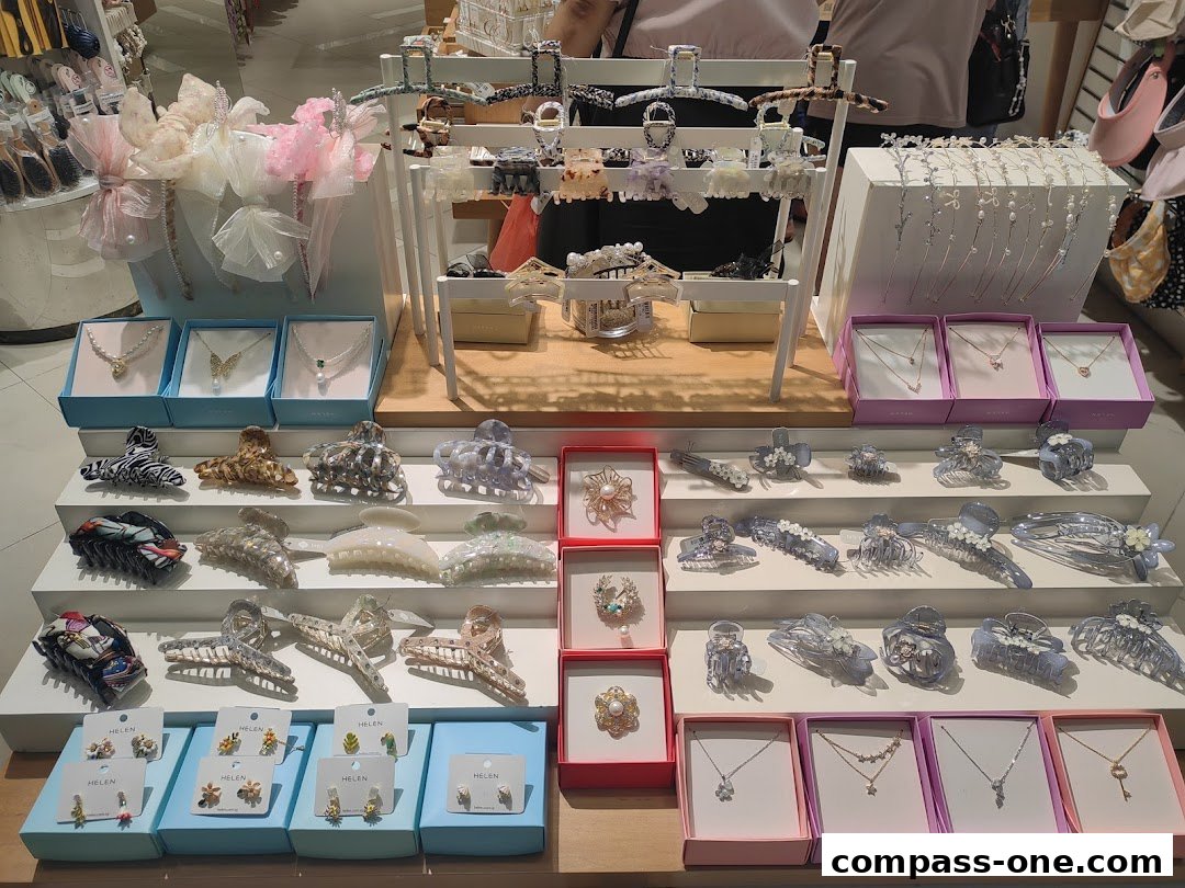 A display of various hair accessories and necklaces, including claw clips and delicate pendants.