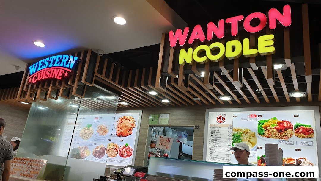 A food stall with signs for 'Western Cuisine' and 'Wonton Noodle' displaying menu items.
