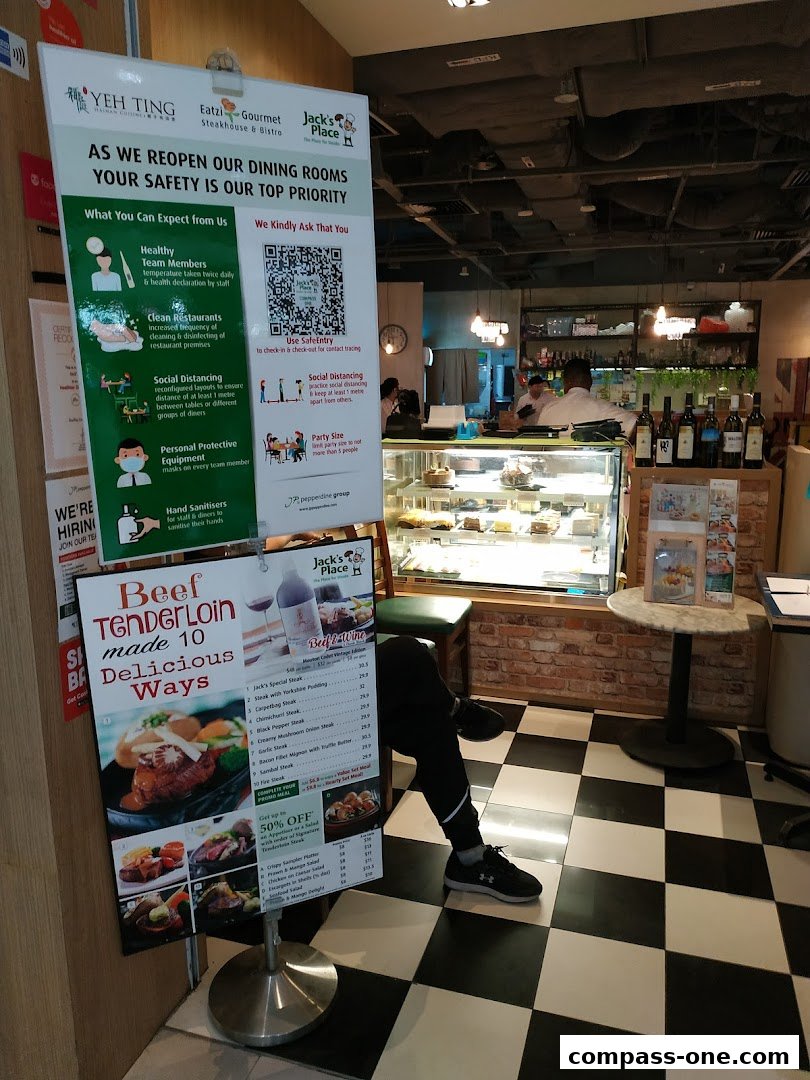 A sign detailing safety measures and a menu for Jack's Place restaurant.