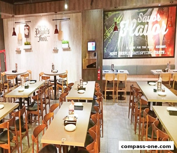 Interior view of a Pizza Hut restaurant with tables, chairs, and a large mural on the wall.