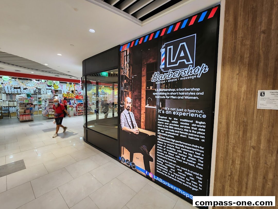 The exterior of LA Barbershop, featuring a large advertisement with text and an image of a barber.