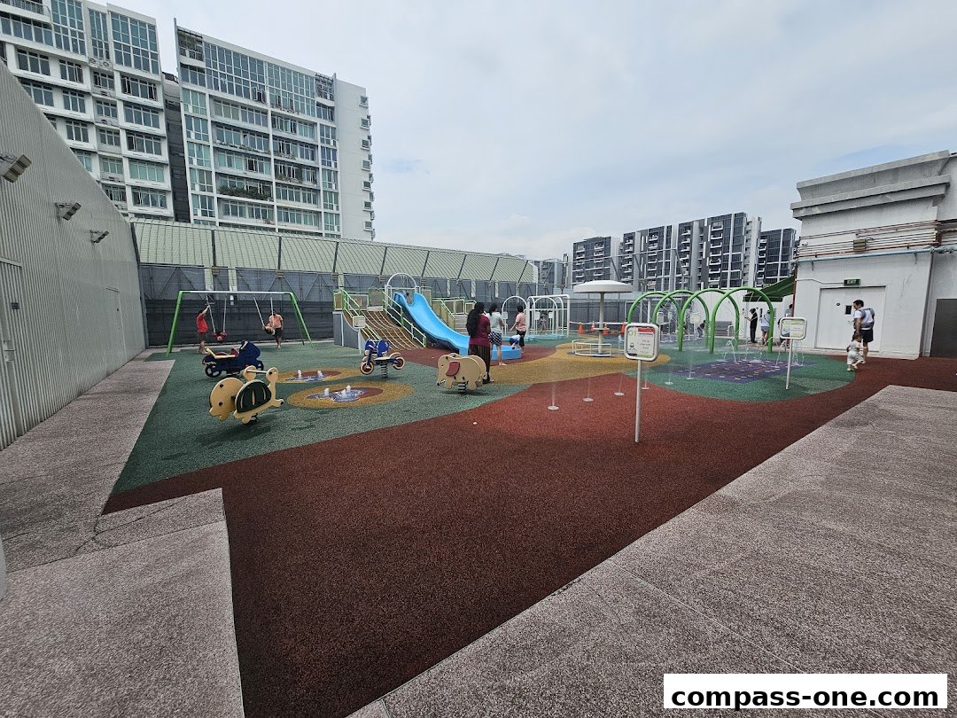 A vibrant outdoor playground with swings, slides, and water features for children.