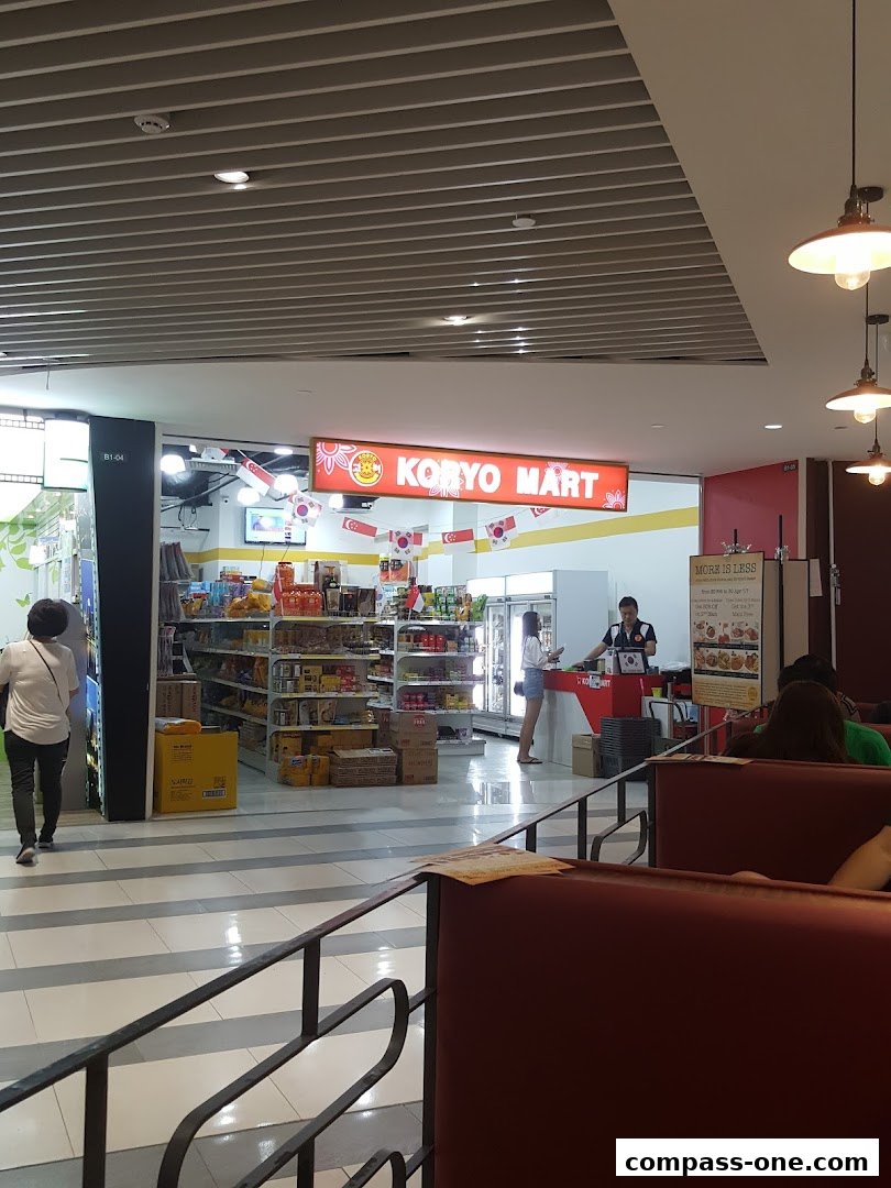Koryo Mart shop interior with shelves stocked with products and a counter with staff.