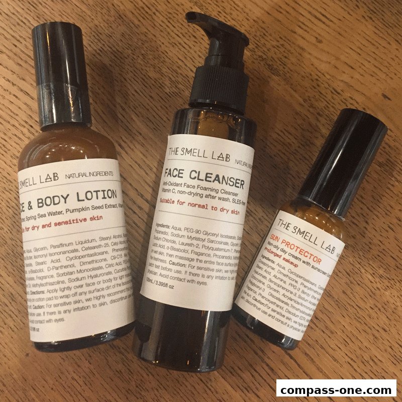 Three amber glass bottles of skincare products from The Smell Lab on a wooden surface.