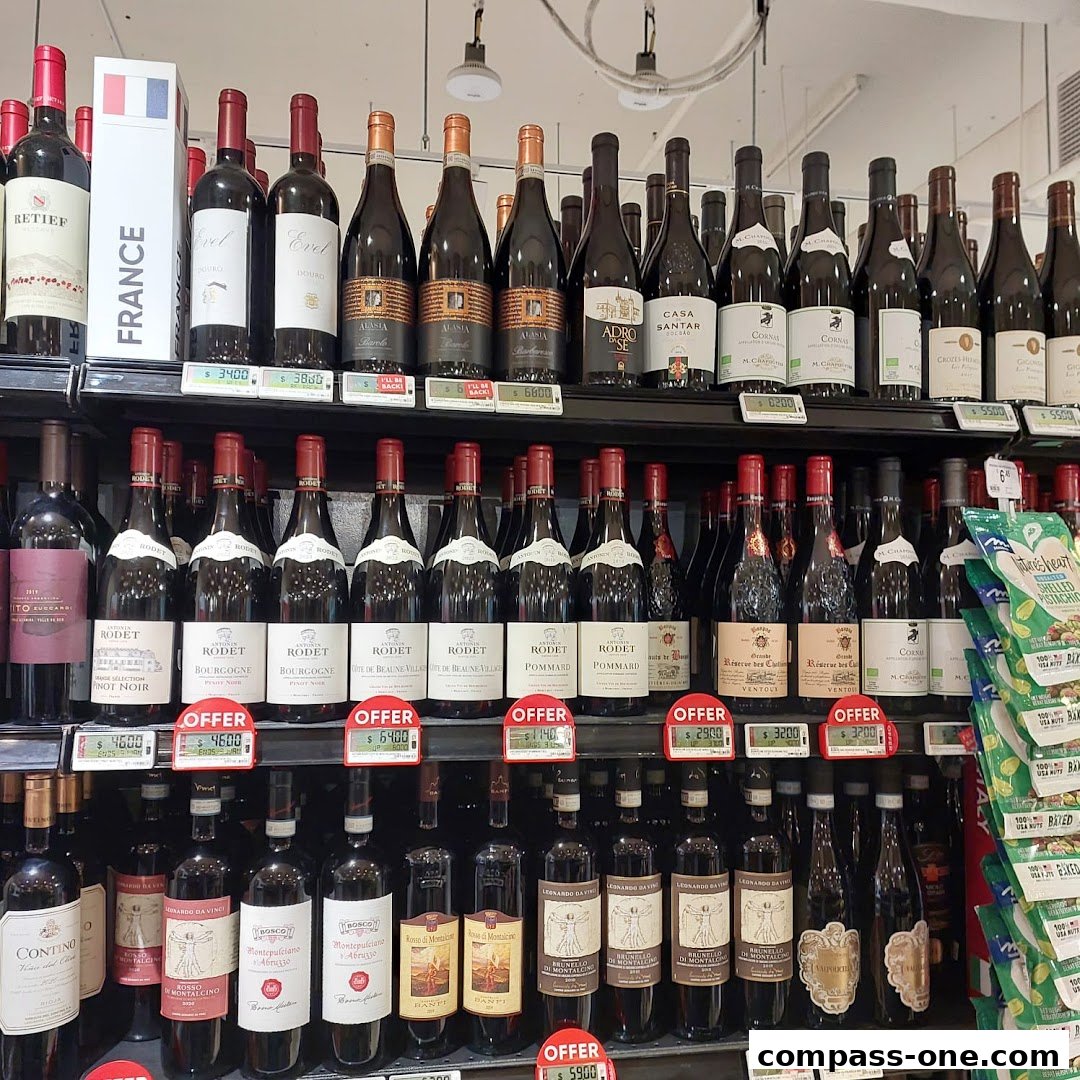 Shelves stocked with various bottles of wine, some with offer tags.