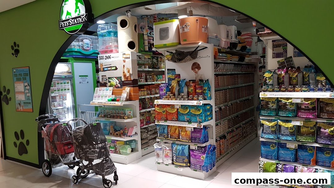 The entrance of a pet store with shelves stocked with pet food and accessories.