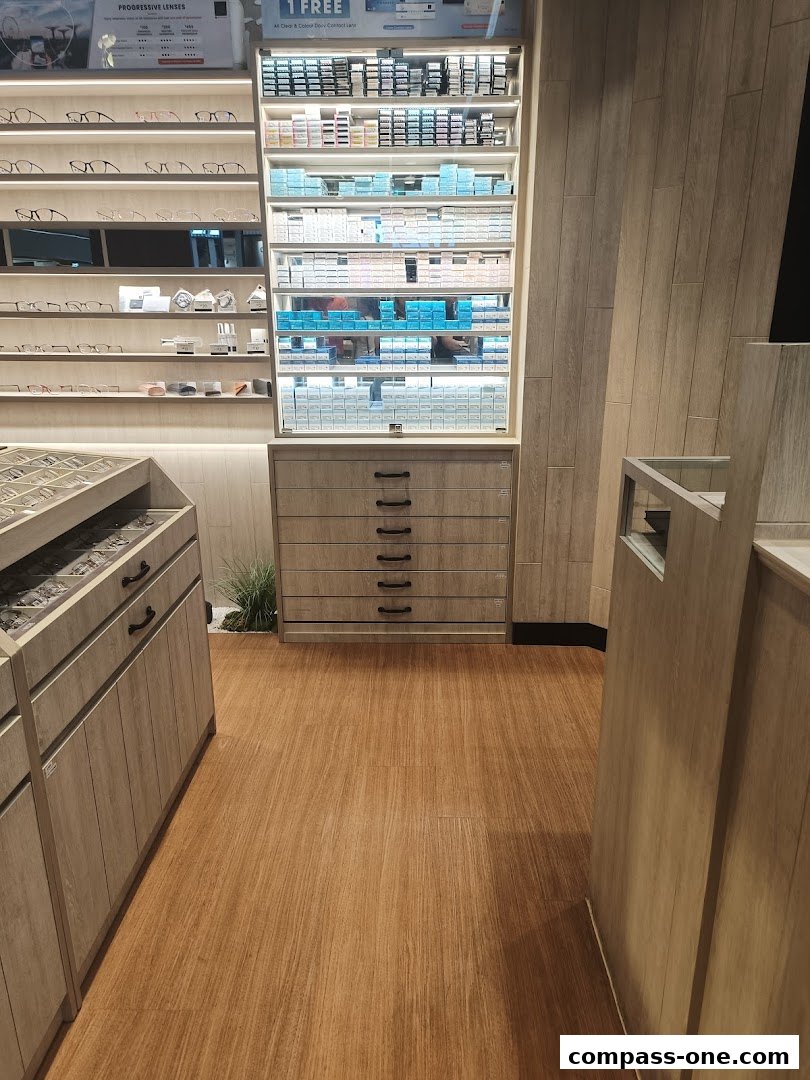 Interior view of an optical shop showcasing shelves of eyeglasses and contact lenses.
