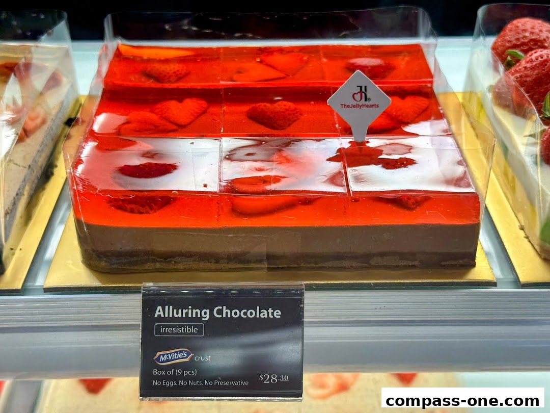 A close-up of a chocolate cake with strawberry jelly topping, labeled 'Alluring Chocolate'.