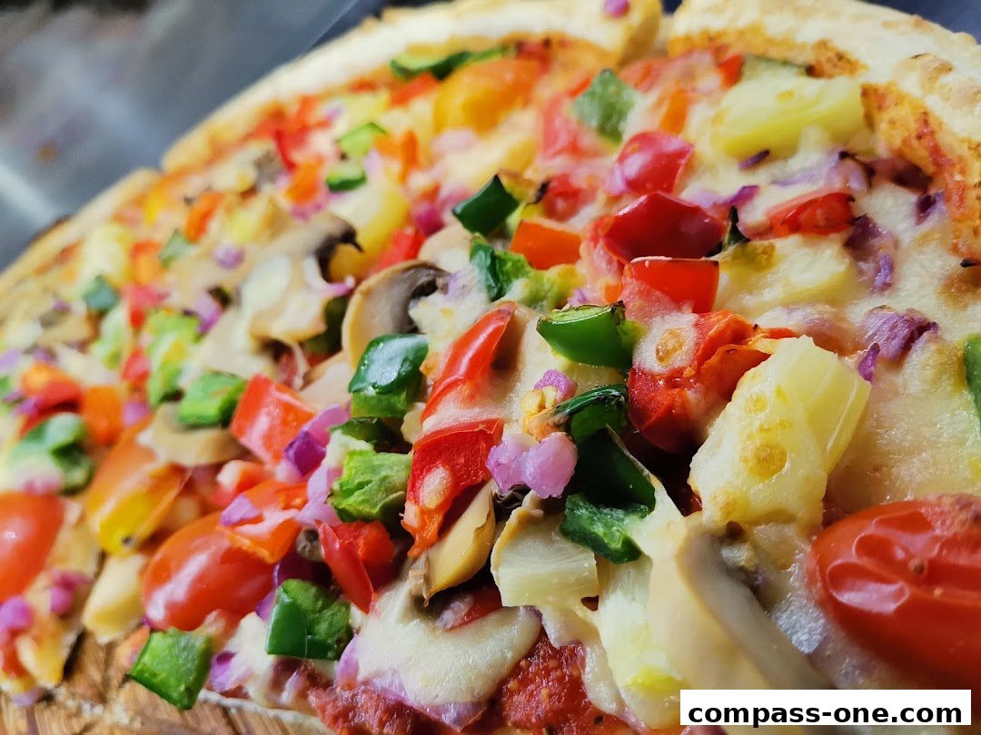 A close-up shot of a delicious pizza topped with various fresh vegetables and cheese.