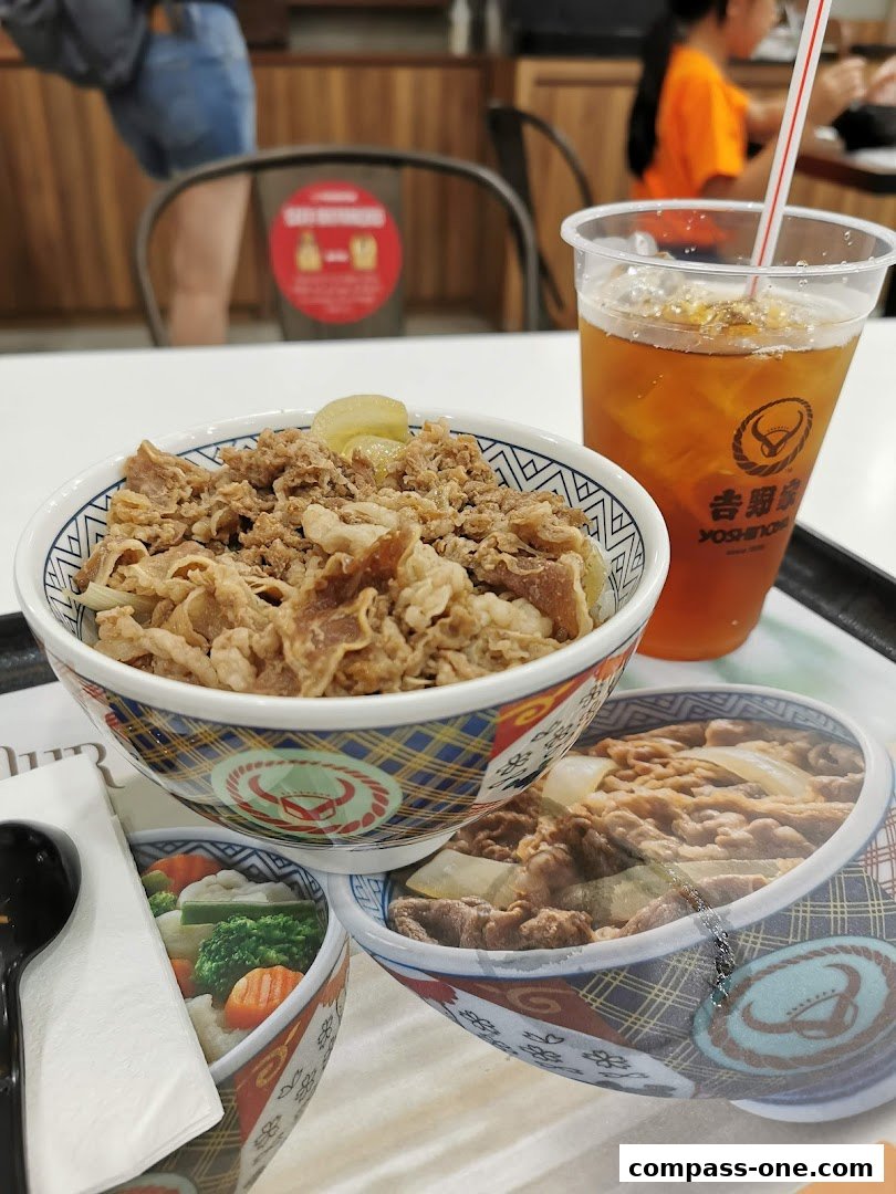 A close-up of Yoshinoya's signature beef bowl and iced tea.