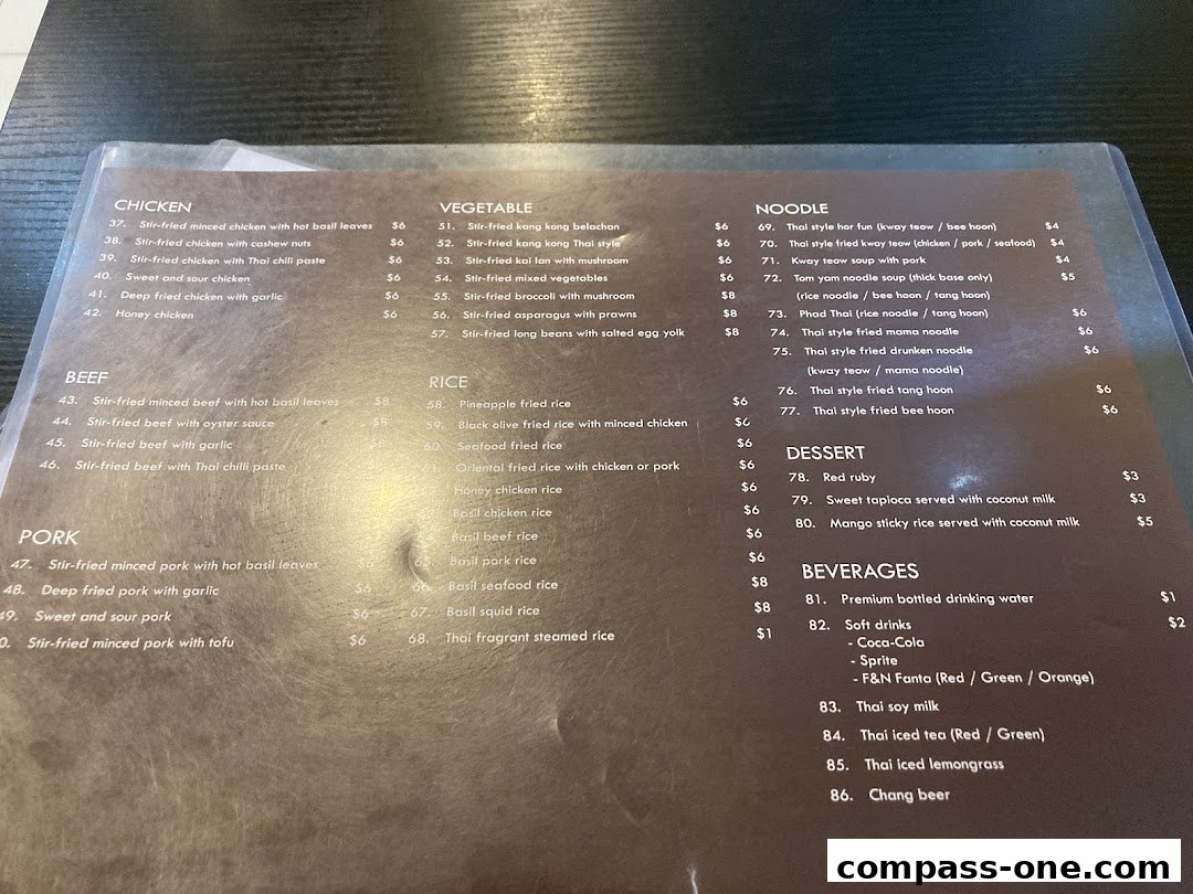 A menu from Nakhon Kitchen featuring Thai dishes like chicken, beef, pork, noodles, rice, and desserts.