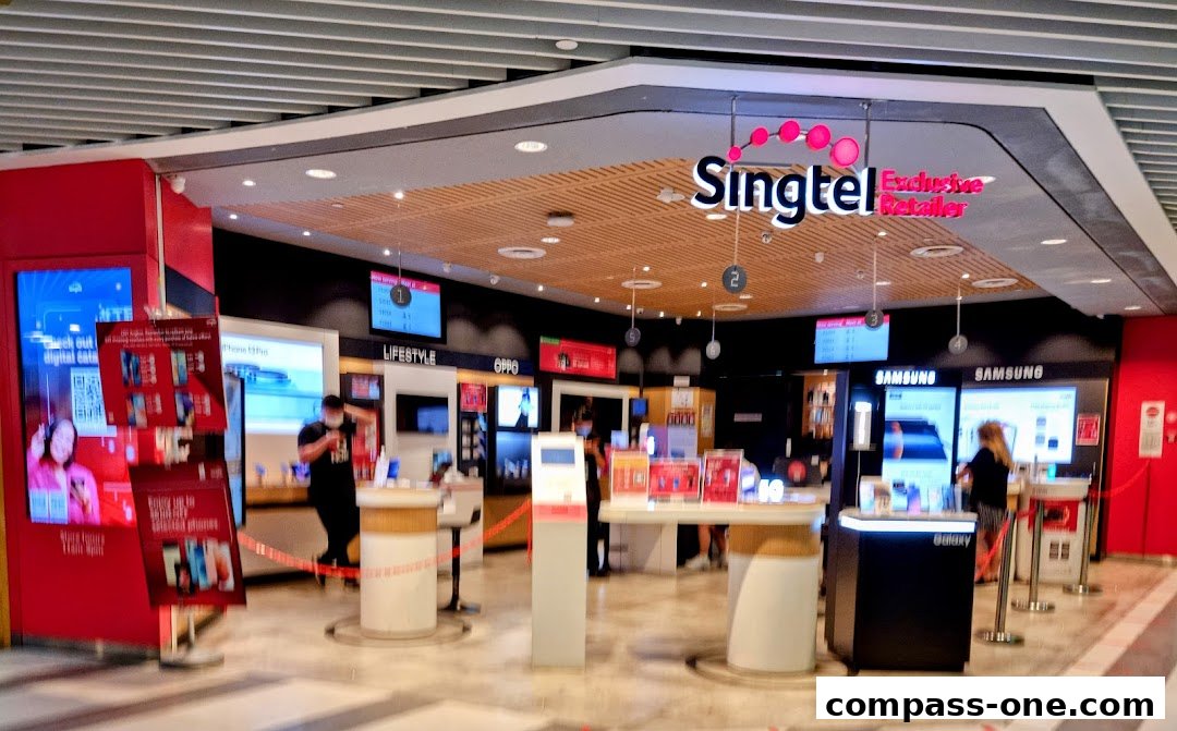 The Singtel Exclusive Retailer shop front displays various mobile phones and promotions.