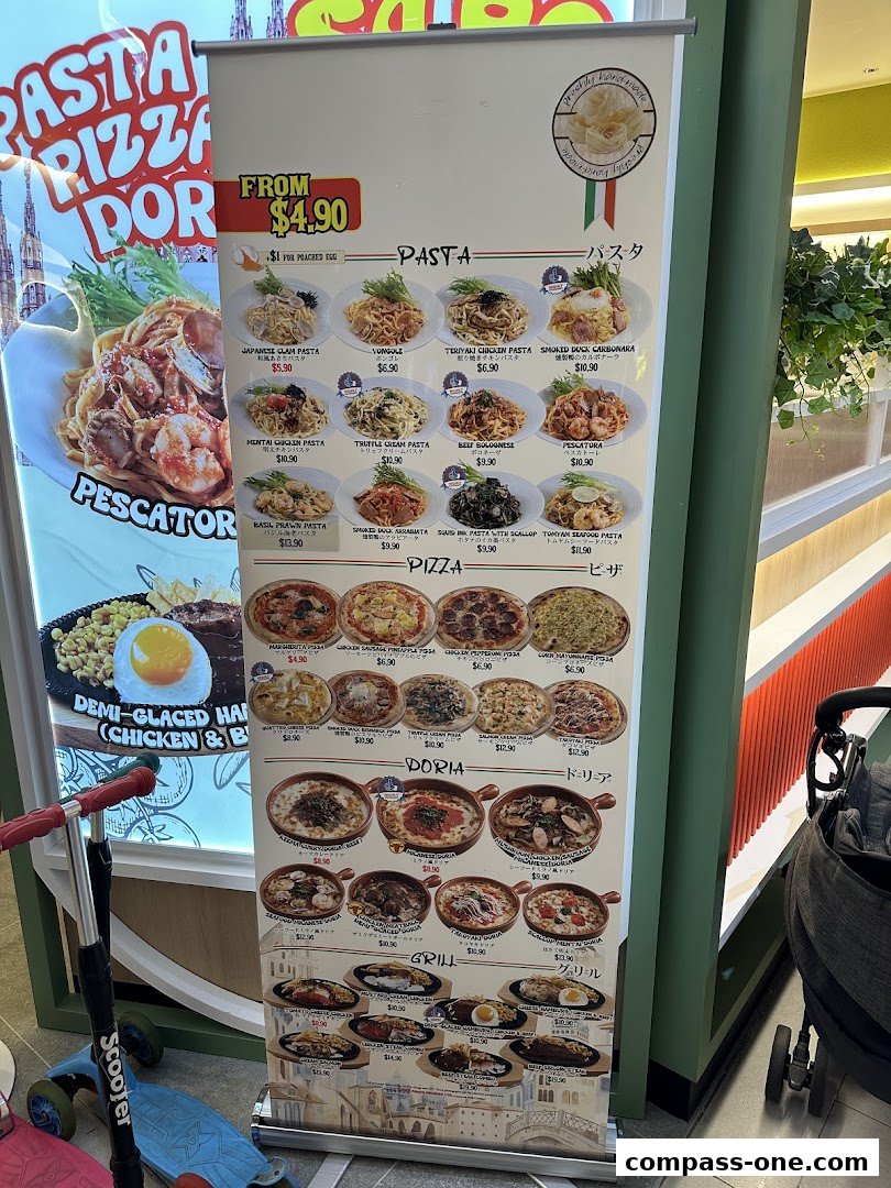 A menu display board showcasing various pasta, pizza, doria, and grill dishes with prices.